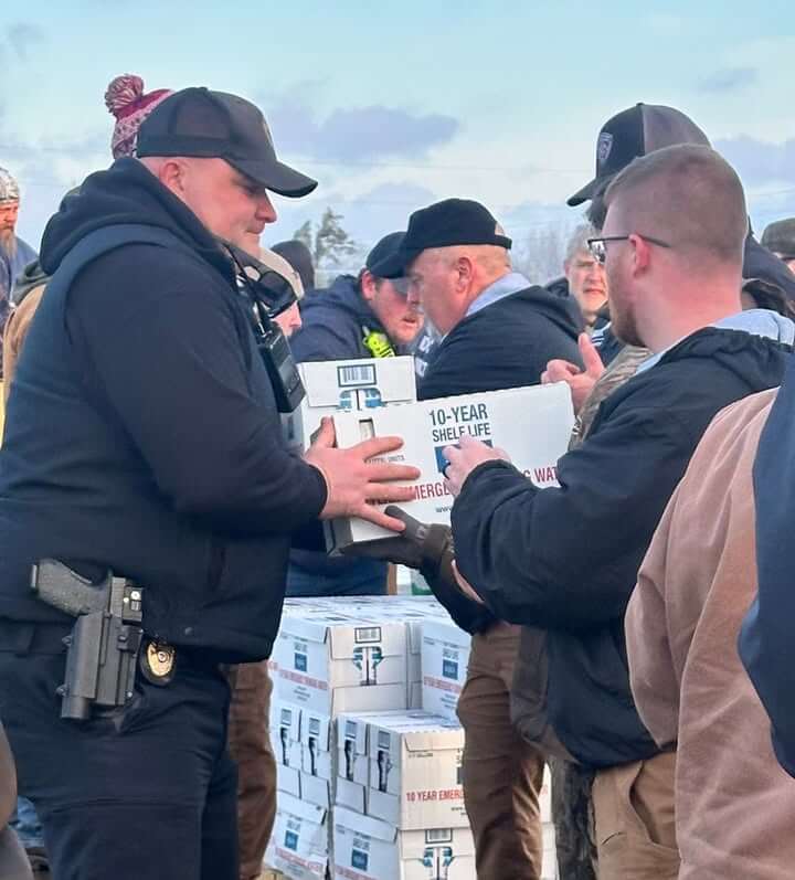 Corinth police help unload National Guard supplies at airport