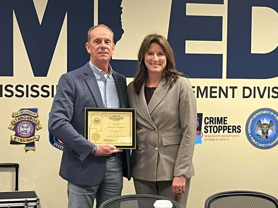 Standards and Training director presents deputy's original certificate to sheriff