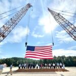 Mississippi News, September 11, 2026: Port Expansion, Health Care and a Day of Remembrance Officials gather beneath an American flag suspended between cranes at the Yellow Creek Port groundbreaking in Tishomingo County, Mississippi.